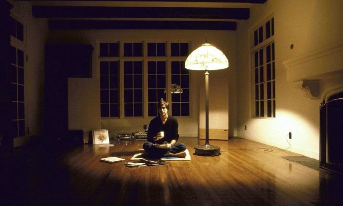 The man is working in the light of the lamp.