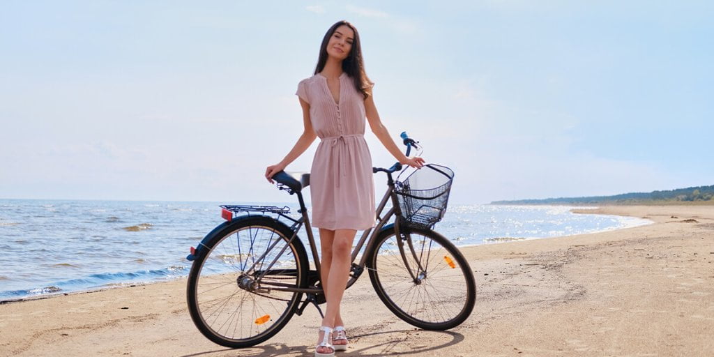 A Girl with Bicycle standing by the sea