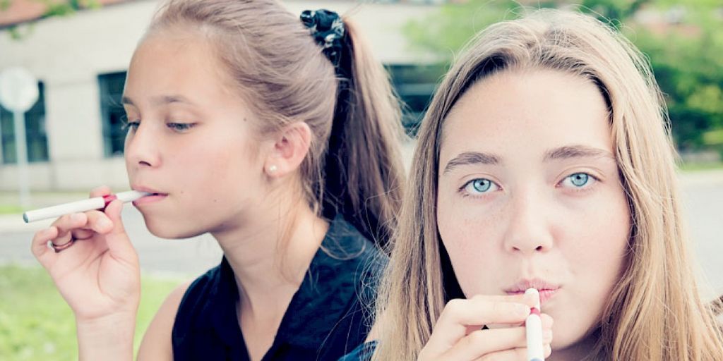 two girls are smoking