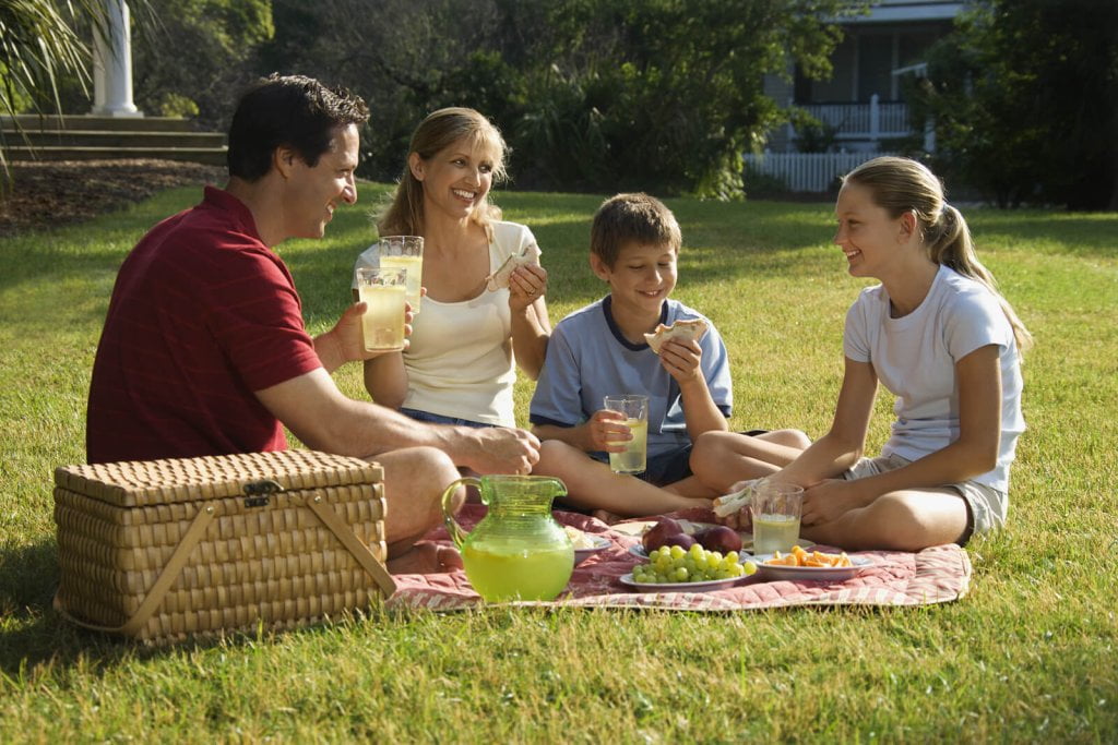 Parents and child eating something together