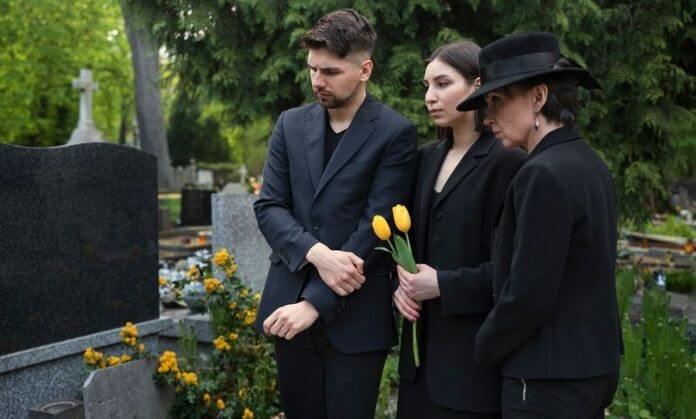 A boy, girl and old women pay tribute to benefactors