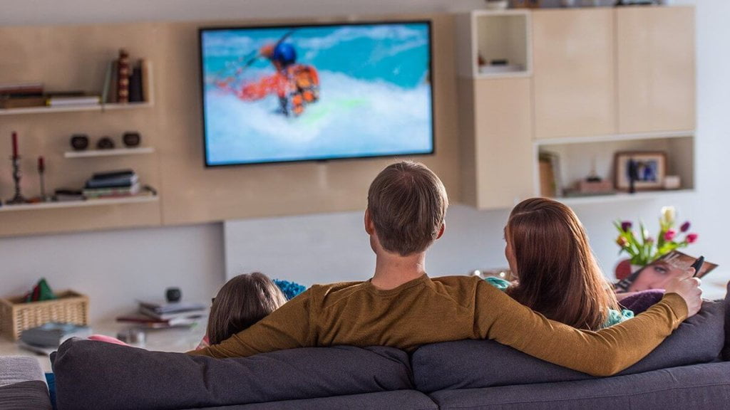 Father and children watching TV