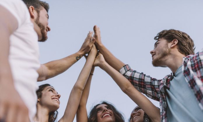 Friends are shaking hands with each other.