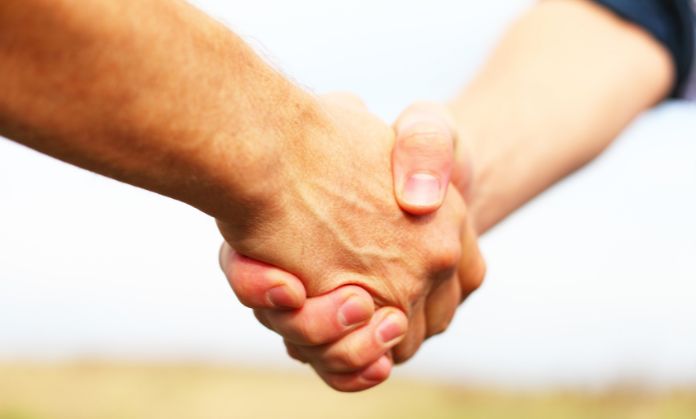 Friends believe in each other and are holding hands.