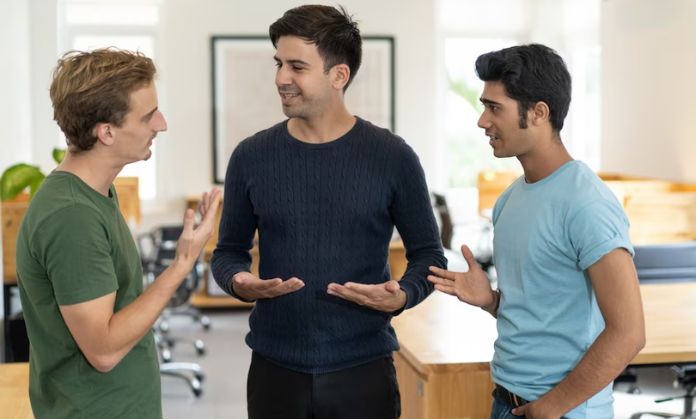 The man in the middle is preventing the 2 men on the sides from fighting