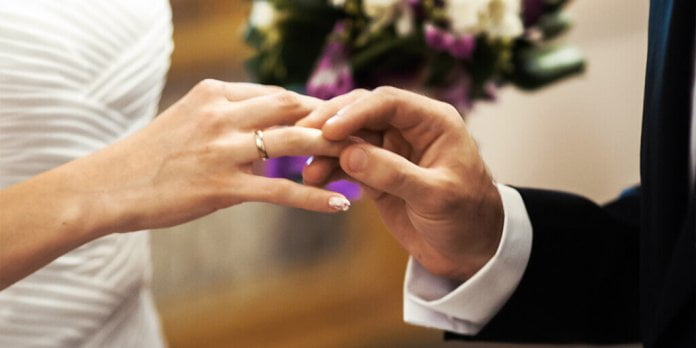man holding hand of a girl with the ring in her finger