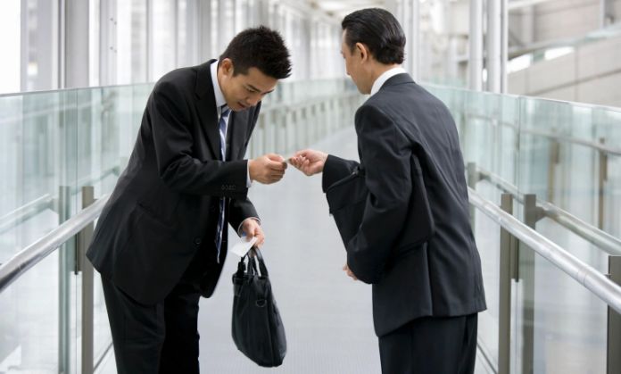 2 Mens Accepting Cash Matters in Japan