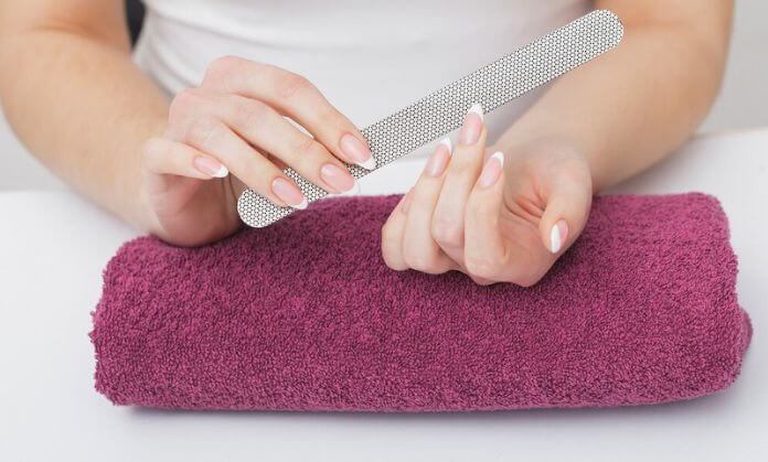 a girl scrape the nail polish