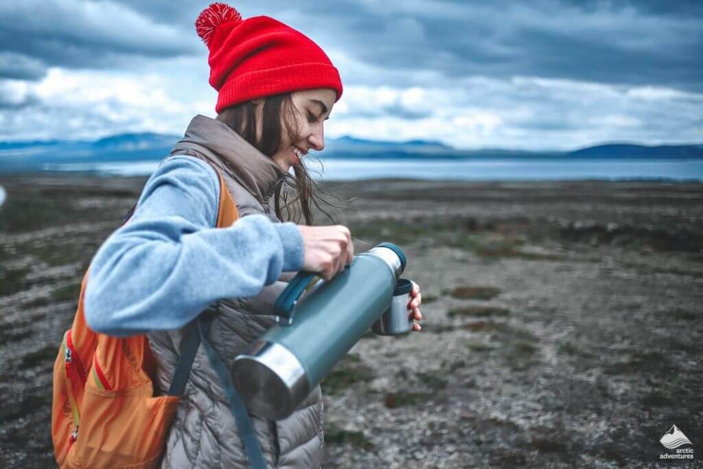 a girl drink water in travel spots
