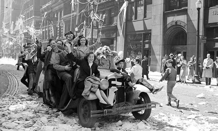 a group of people are very excited on v-j day.