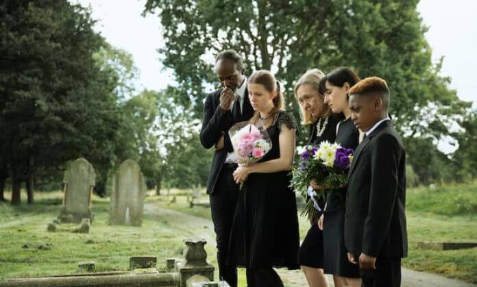 People standing in a cemetery.