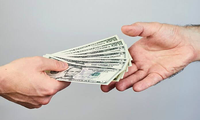 a guy giving money and another guy taking money.