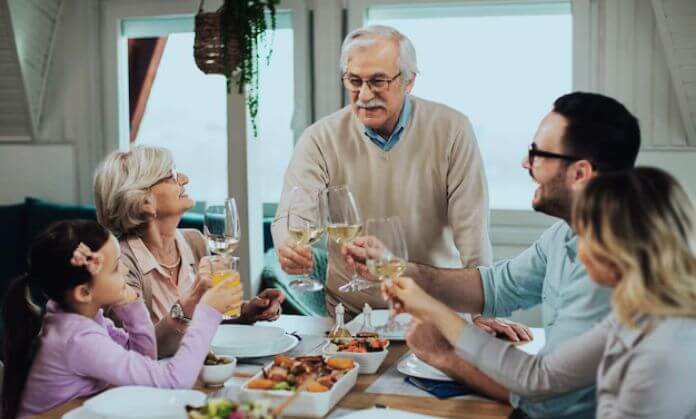 Family toasting at a dinner table