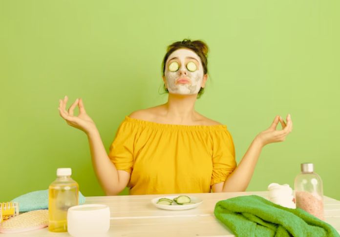 Women sitting with the cucumbers on her face due to skincare