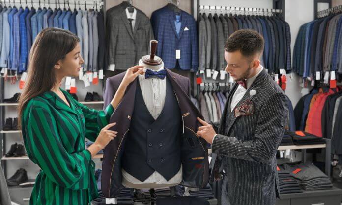 a boy helping a girl to tie a suit 