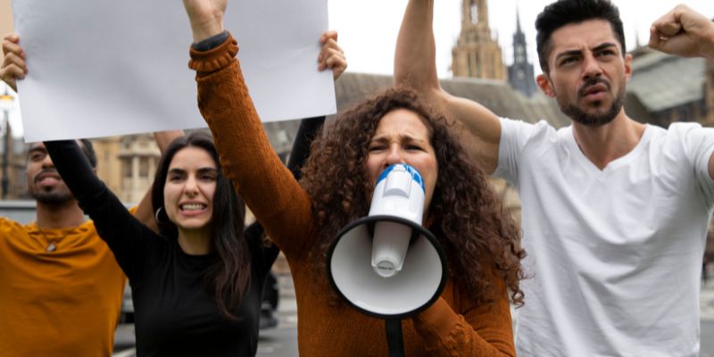 a group of people protesting with a megaphone 
