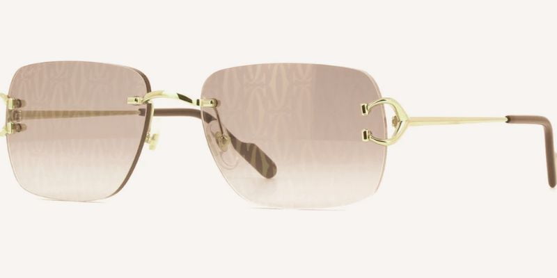 a pair of cartier sunglasses with a gold frame