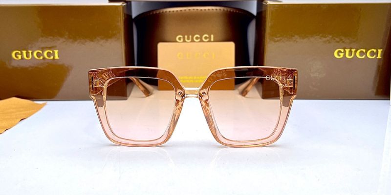 a pair of glasses with a Gucci box behind them