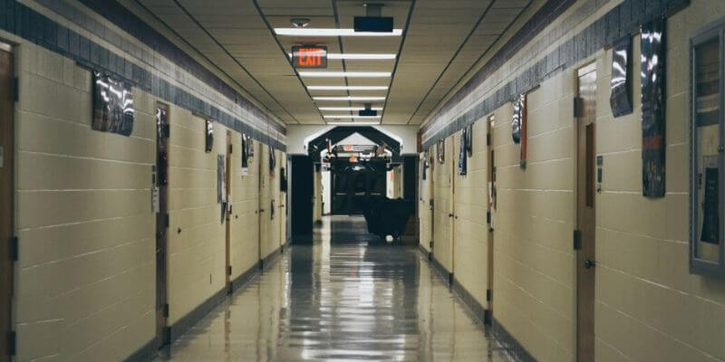 a hallway with doors and signs