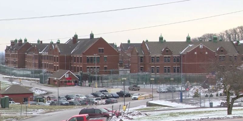 a parking lot with cars in front of a SCI Waymart building