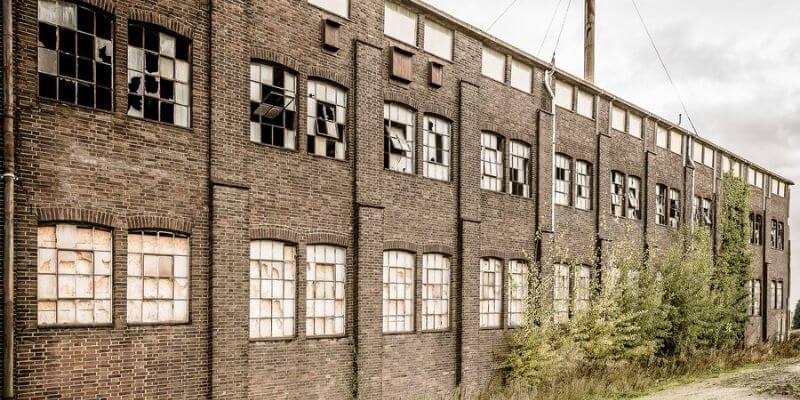 a brick building with broken windows
