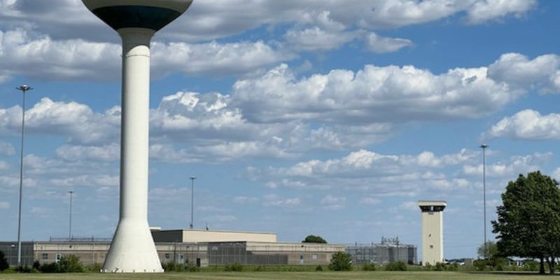 a large white tower with a blue sky and clouds 
