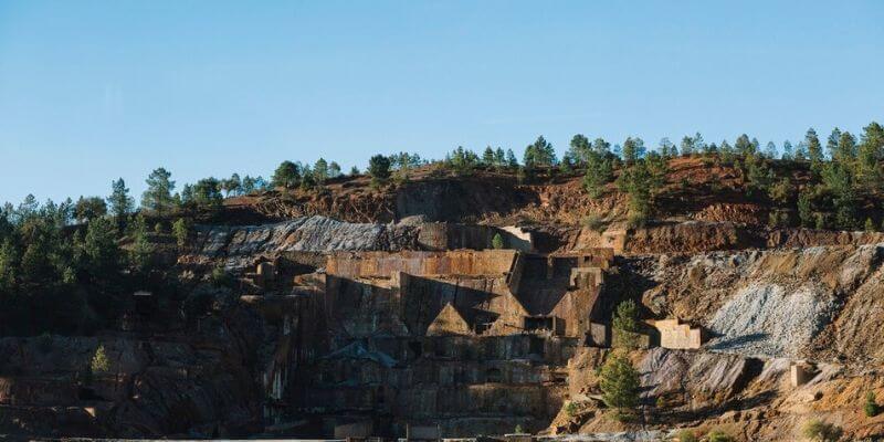 a rocky hill with trees on the side