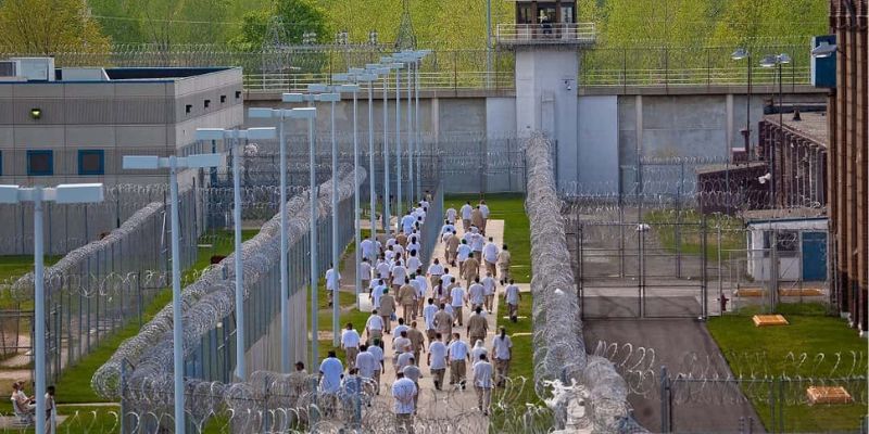 a group of people walking in a wabash prison 
