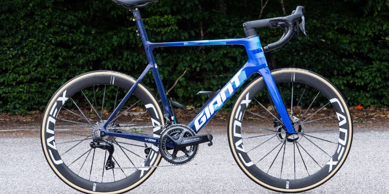 a blue bicycle with white wheels 