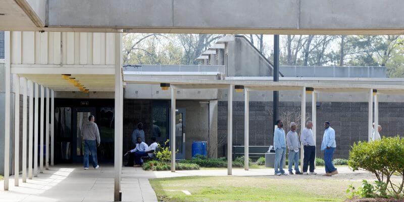 a group of men standing outside of a building