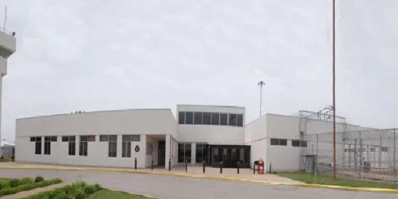 a white building with a parking lot 