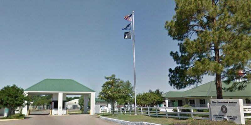 a flagpole with flags flying in the wind
