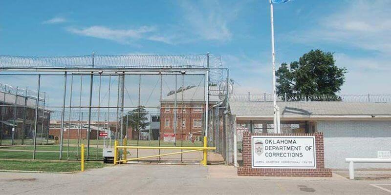 a gated entrance to a prison 