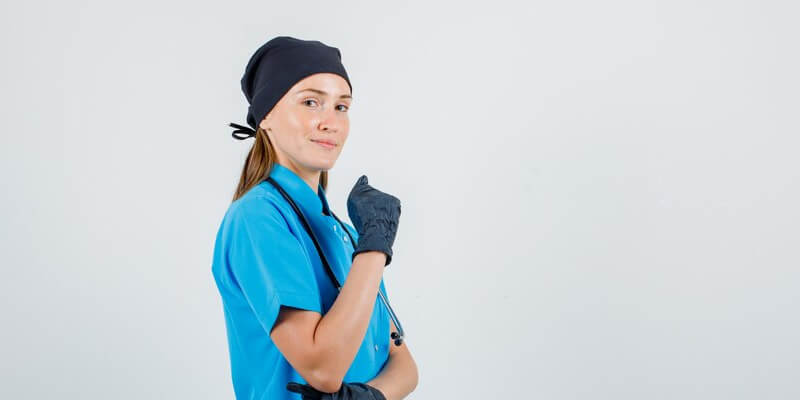 a person wearing a scrubs and black gloves 