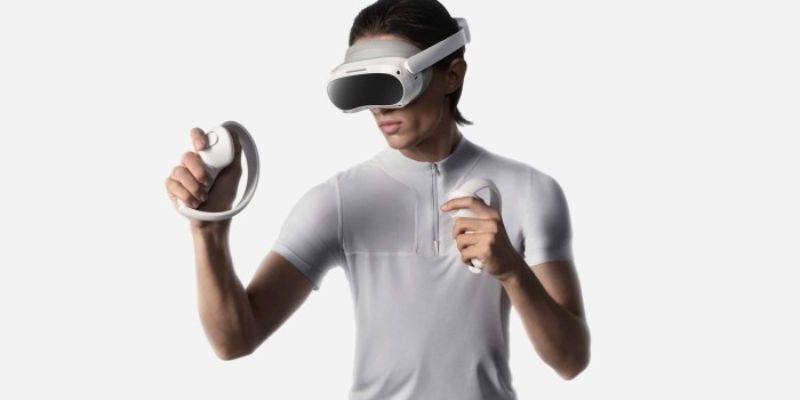 a person wearing PICO 4 ALL in one Headset and holding controllers 