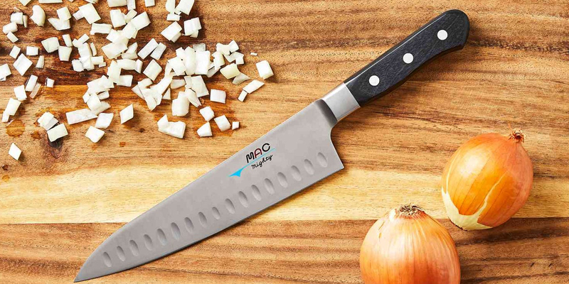a knife next to a onion 